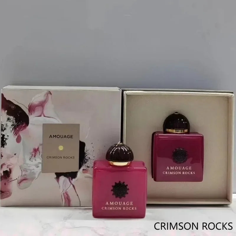 Amouage Crimson Rocks perfume set with two deep magenta, square glass bottles and decorative display box.