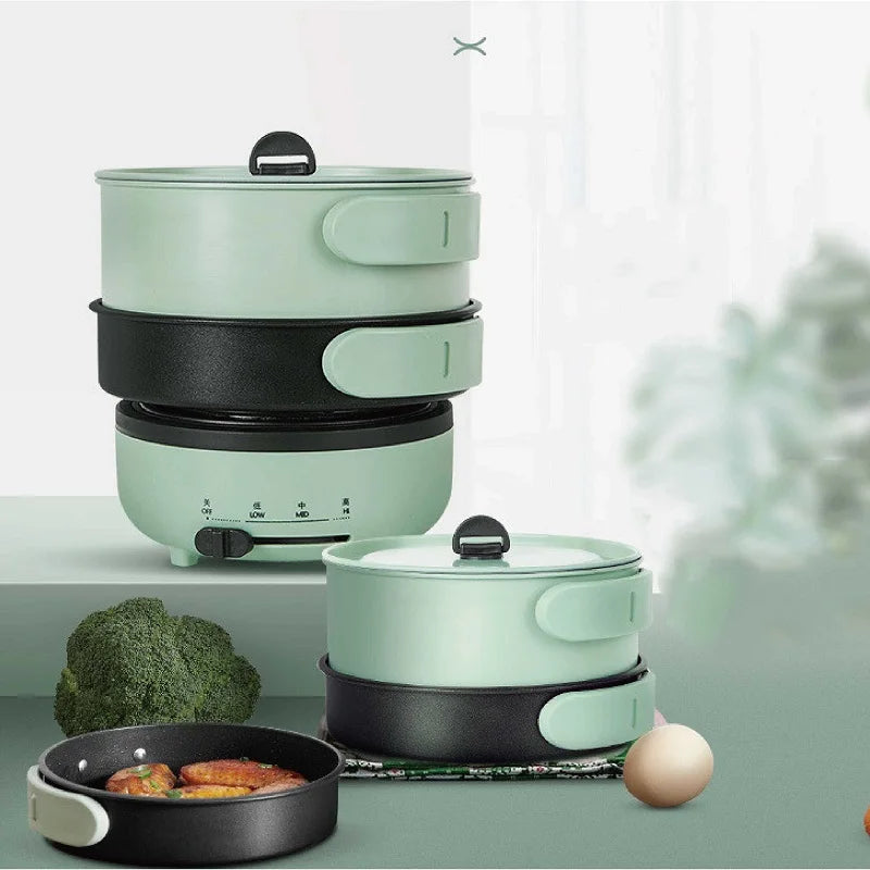 Stacked green electric cooking pot set with transparent lid and black nonstick pan