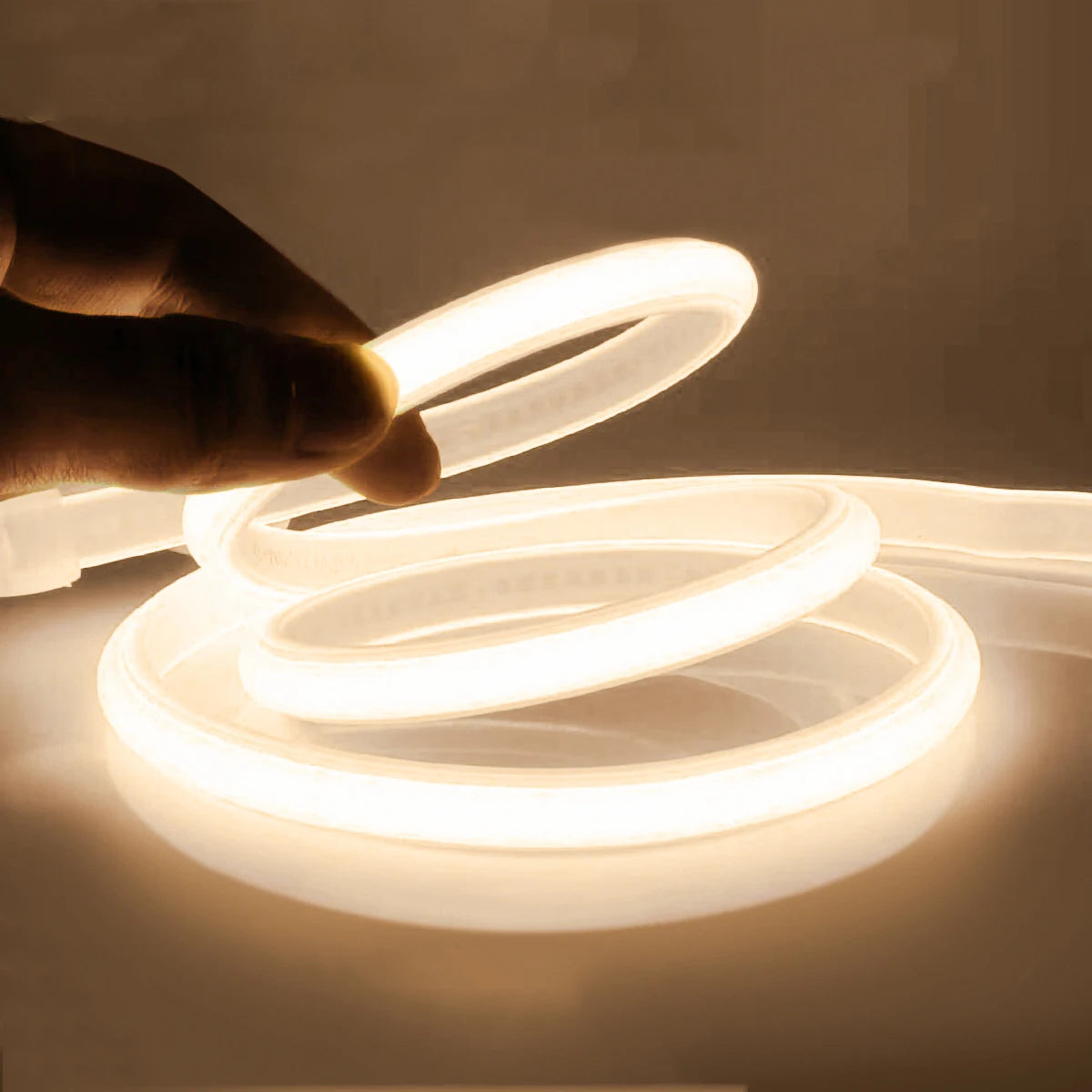 Flexible neon LED tape light strip in warm white, held in hand