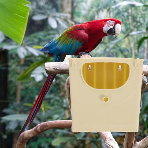 Beige hanging bird nesting hut with round front opening and yellow interior tray
