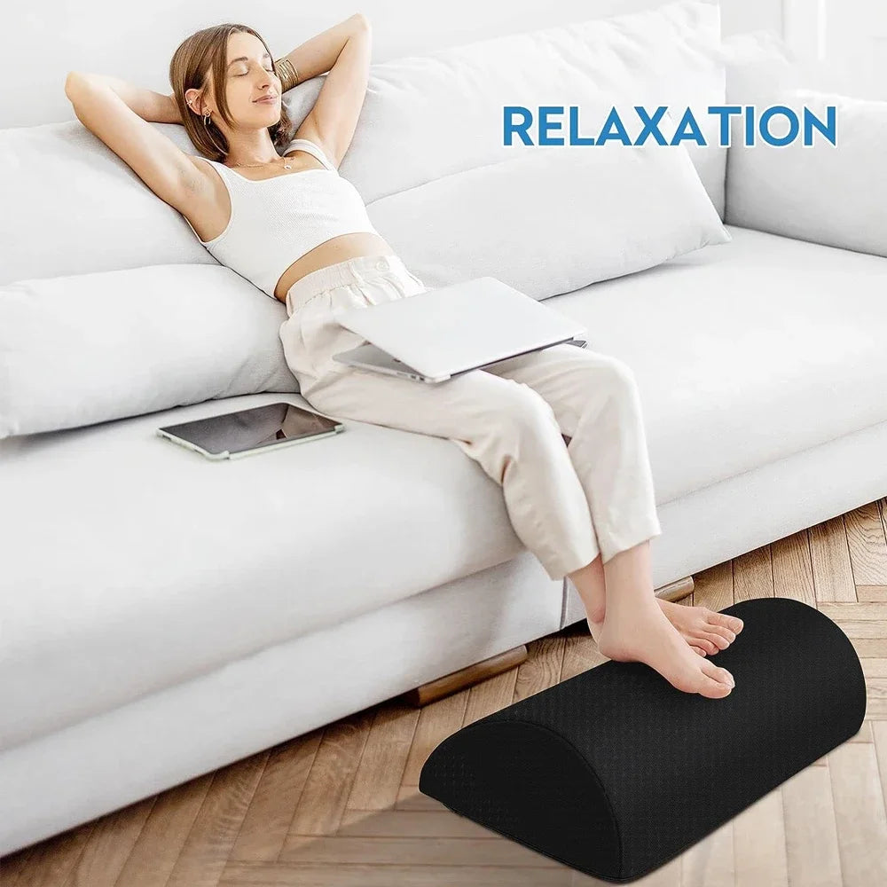 Black ergonomic memory foam foot rest for under desk with non-slip base for comfort and fatigue relief while sitting.