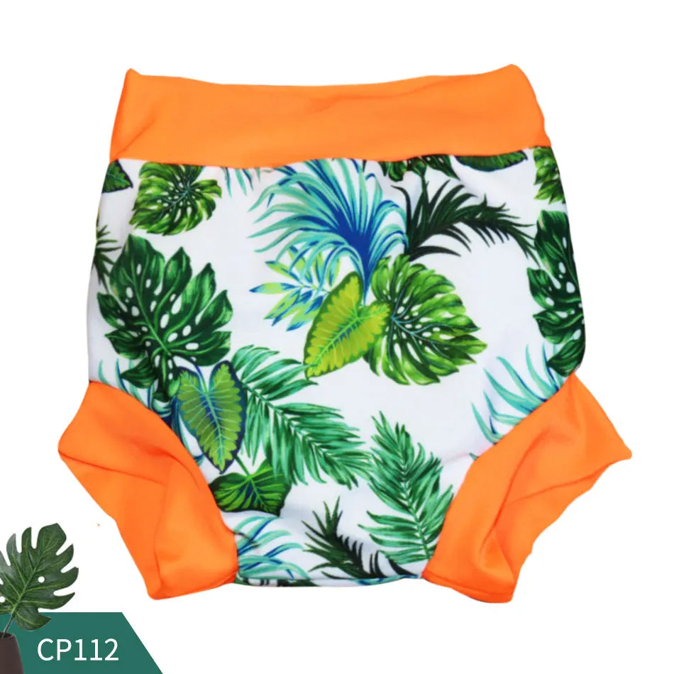 Reusable baby swim diaper, model CP112, with tropical green leaf print and bright orange trim.