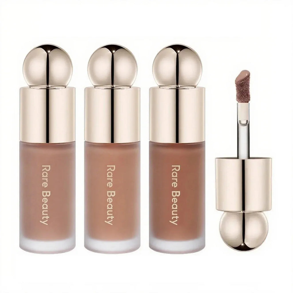 Rare Beauty liquid contour trio with doe-foot applicator, featuring matte nude shades in elegant metallic-capped bottles.