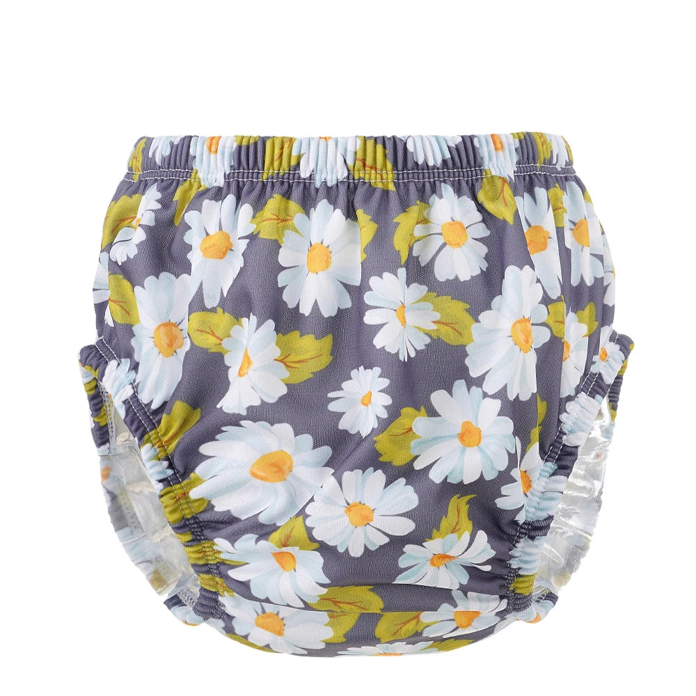 Reusable baby swim diaper featuring a white daisy flower print on a dark grey background.