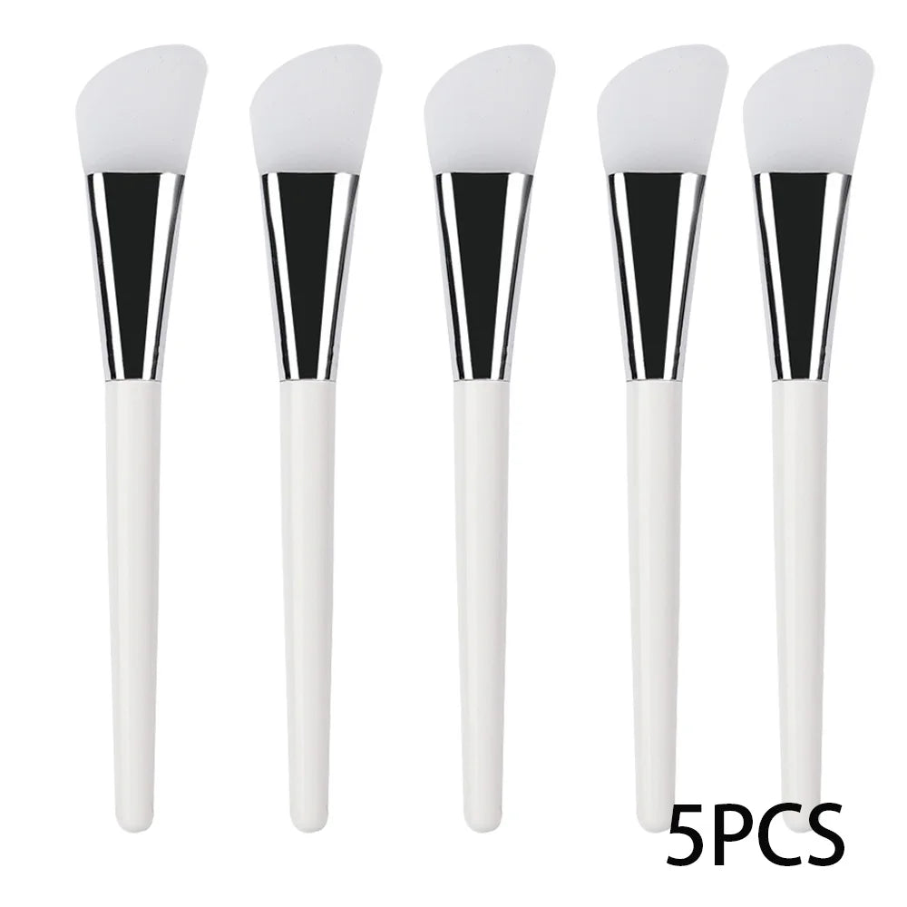 Five face mask brushes with soft white silicone spatula tips, silver ferrules, and slim white handles.