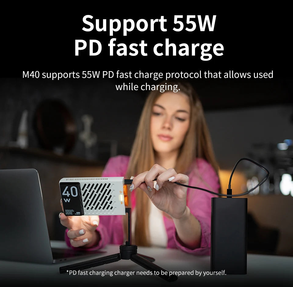 M40 LED video light, white rectangular panel on a small tripod, connected to a power bank for 55W PD fast charging.
