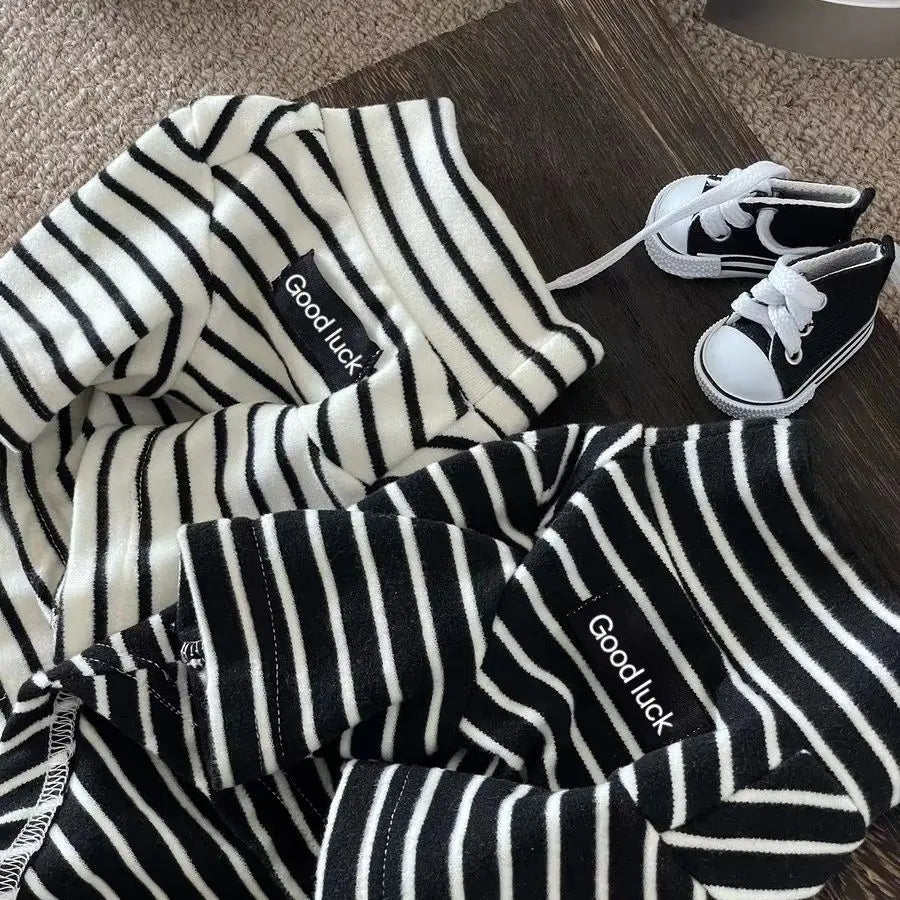 Cozy black and white striped thermal dog shirts for small breeds with matching mini sneakers for autumn and winter.