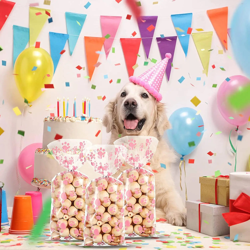 Clear cellophane treat bags with pink paw prints for dog birthday party favors and heat-sealable pet snack packaging.