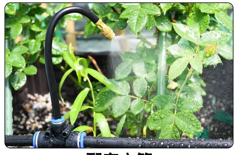 Sprinkler nozzle misting water onto green leaves
