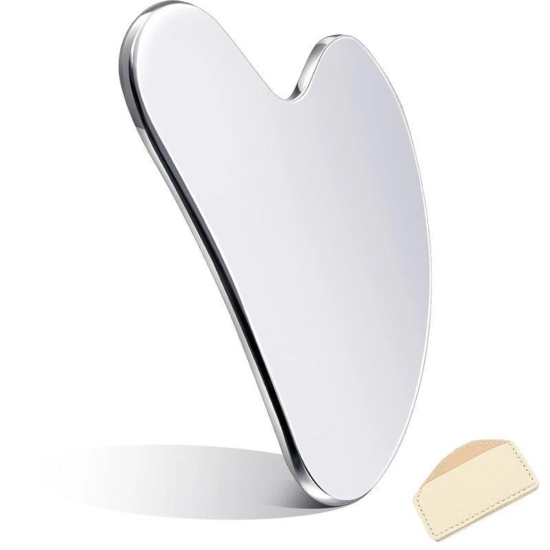 Heart-shaped stainless steel gua sha tool for facial massage, featuring a smooth, reflective surface and storage pouch.