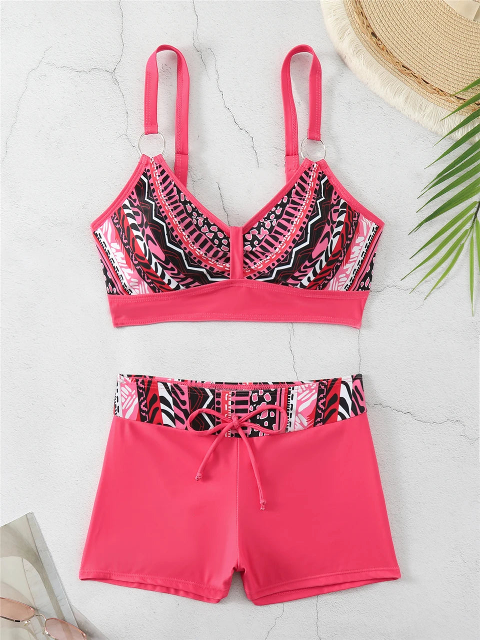 Tidesmit hot pink two-piece bikini featuring a printed sports top with ring straps and matching high-waisted shorts.