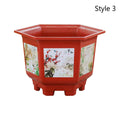 Red plastic bonsai planter with white floral artwork on the front and sides