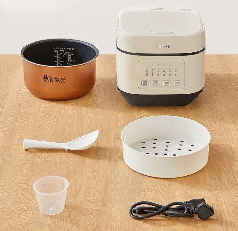 Rice cooker kit with white lid unit, copper inner pot, steam rack, and power cord.