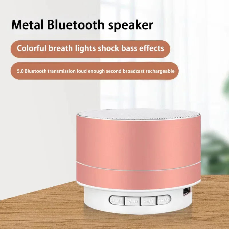 Pink portable Bluetooth speaker on tabletop with silver grille and control base