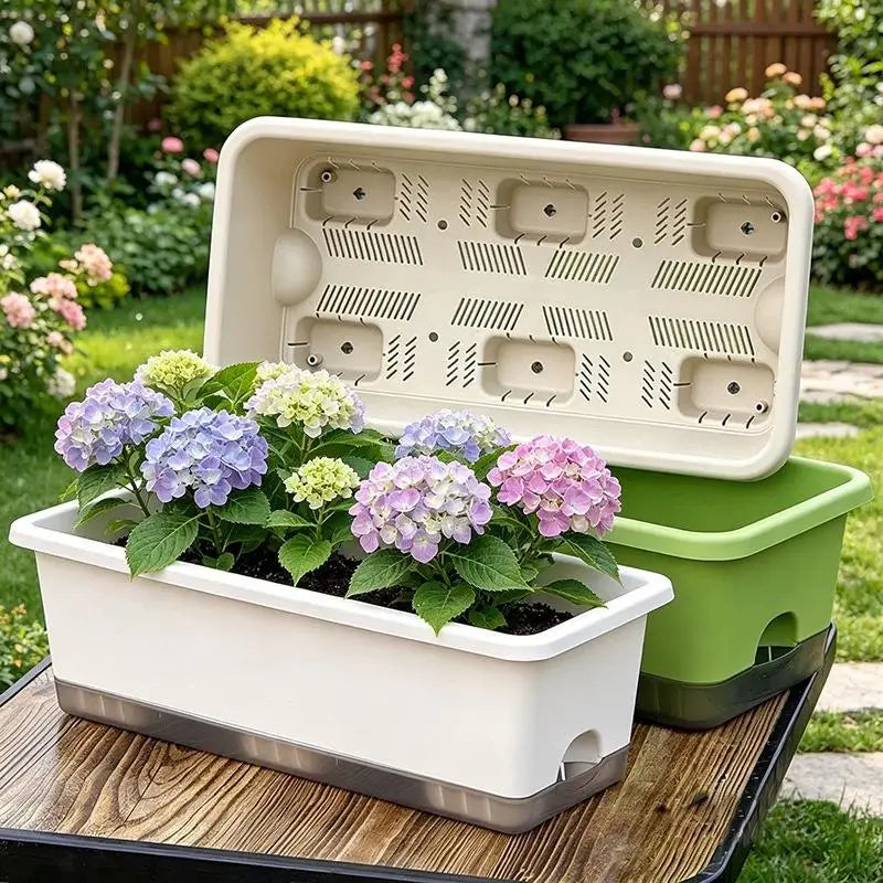 Green and white self-watering planter box with open base and drainage panel