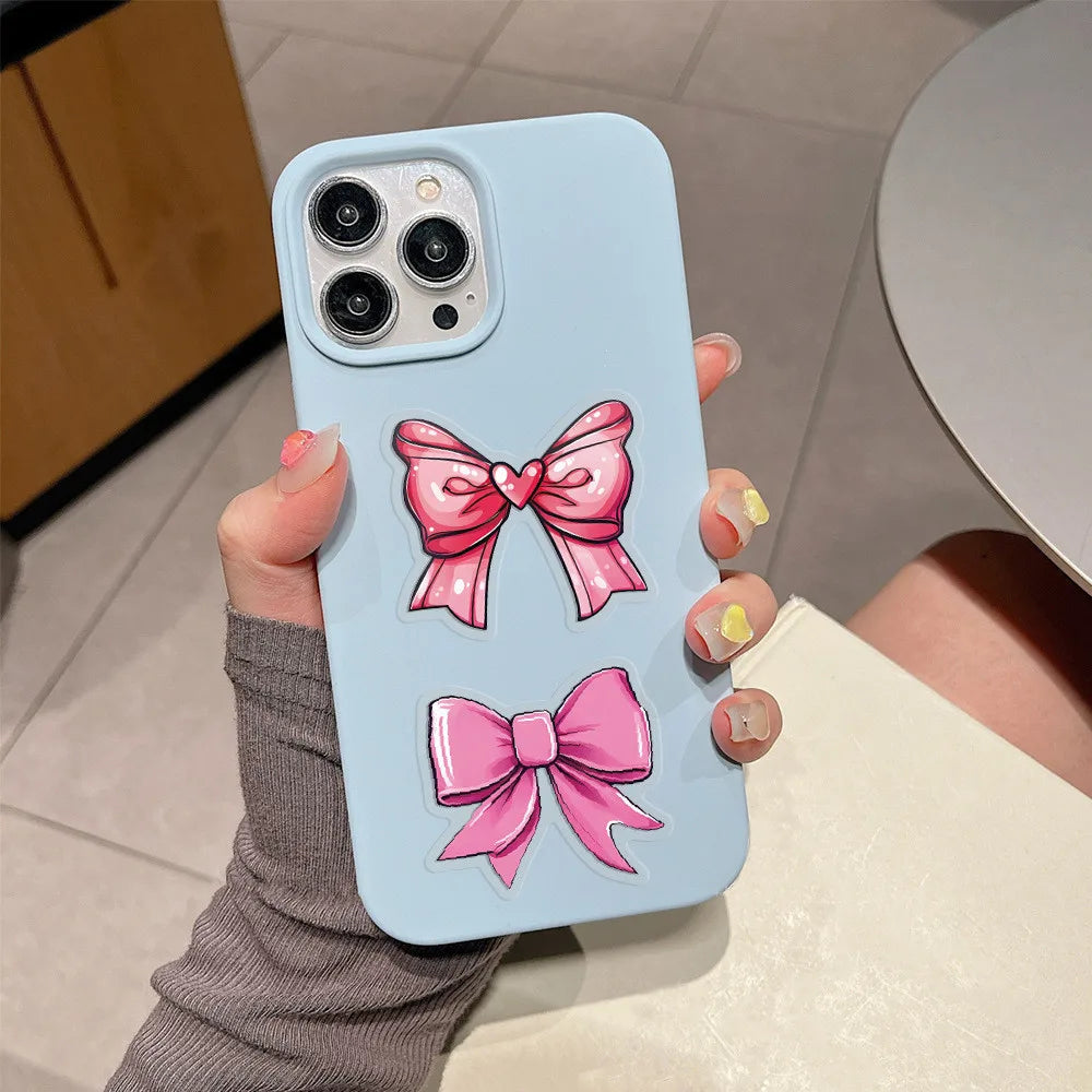 Waterproof pink bow PET stickers on a blue phone case for aesthetic journaling and creative decoration.