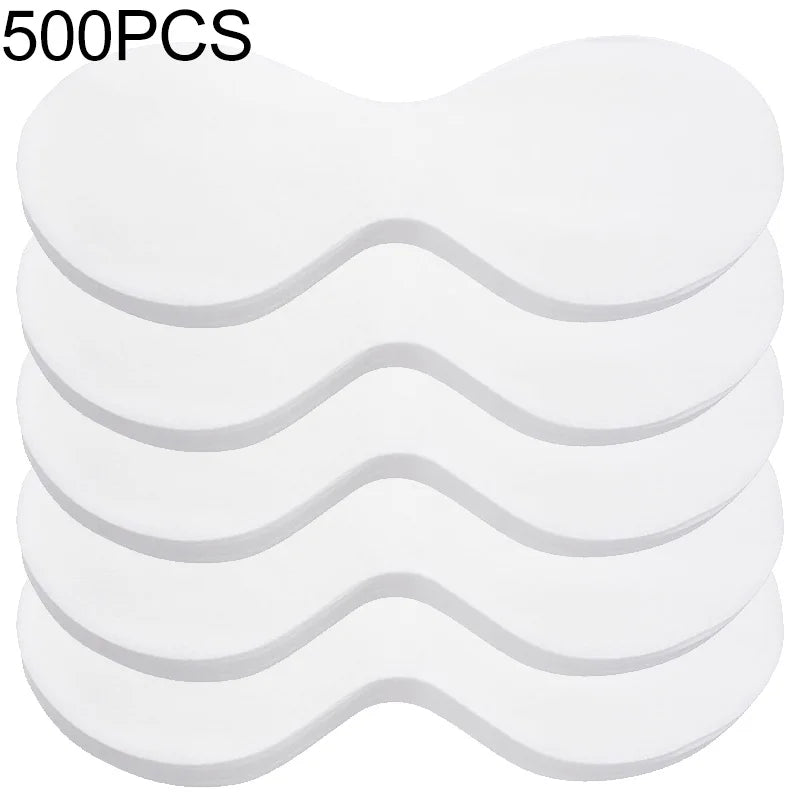 A stack of five white, butterfly-shaped disposable cotton eye mask sheets for skincare.