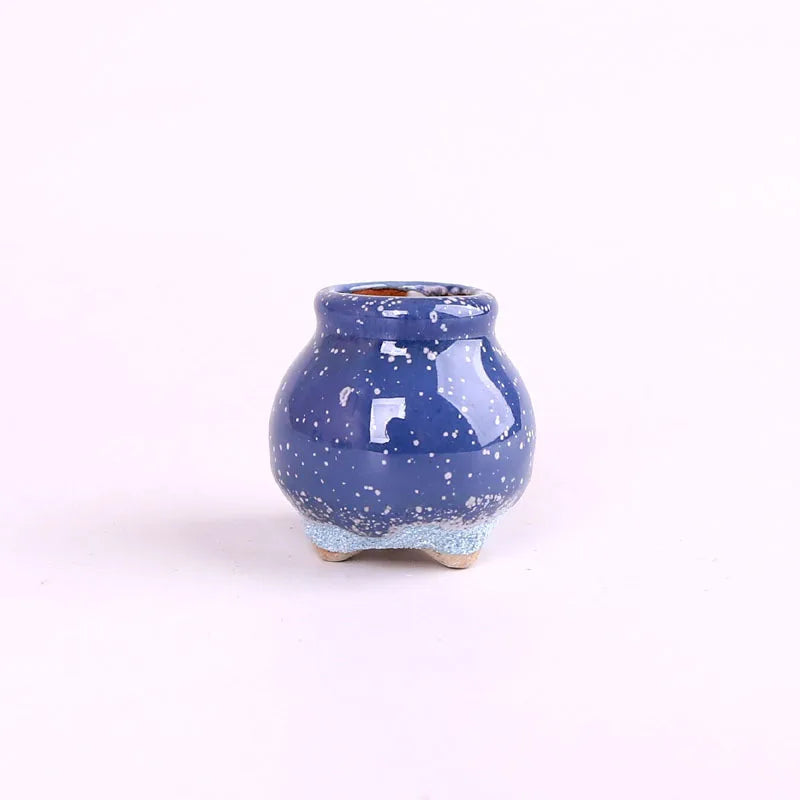 Mini ceramic flowerpot for succulent, speckled dark blue crackle glaze, small tripod base.