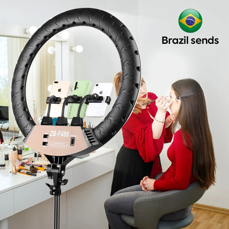 Black circular LED ring light with three phone mounts for content creation, standing on a tripod base.