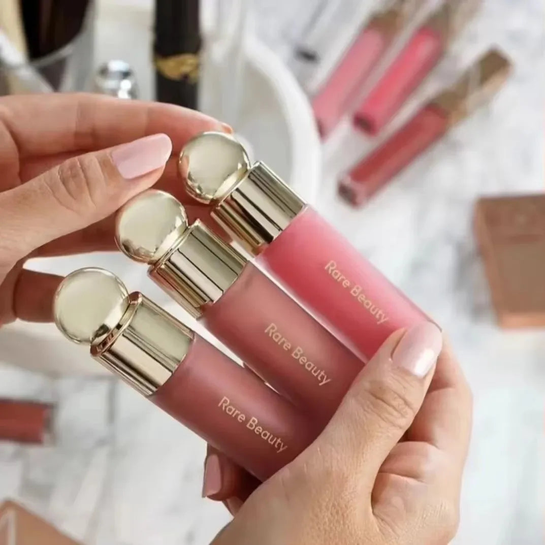 Rare Beauty matte lipstick set in rich pink and nude shades with gold caps for a smooth, moisture-rich lip makeup finish.