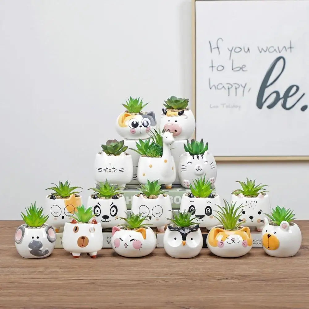 Set of cute animal-face ceramic planters with small green succulent plants, assorted colors