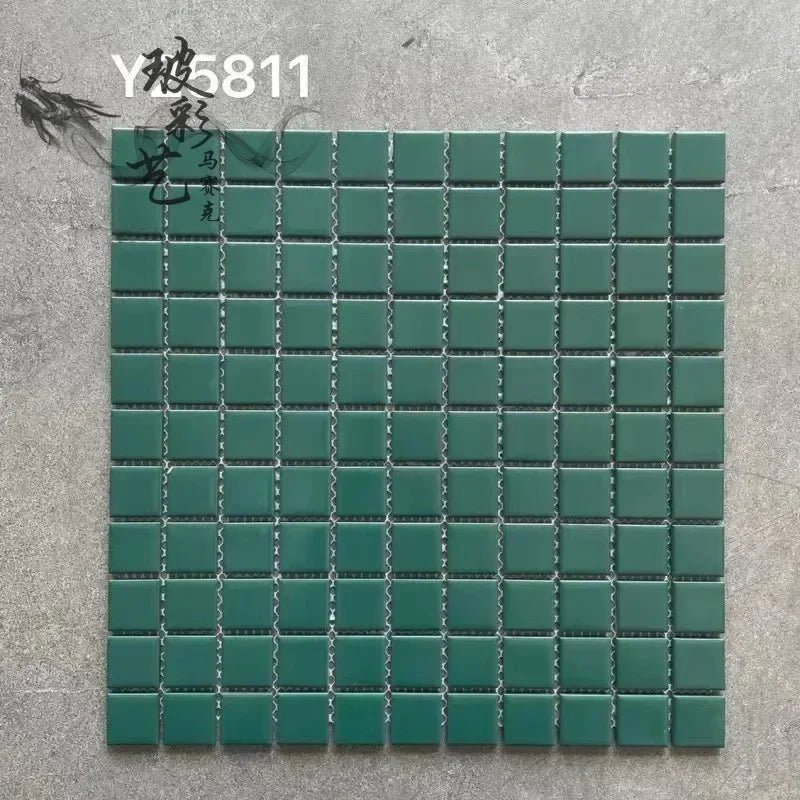 Ceramic mosaic tile sheet with small square teal green tiles on grid backing