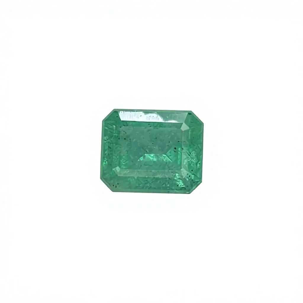 Octagonal emerald-cut green gemstone on white felt