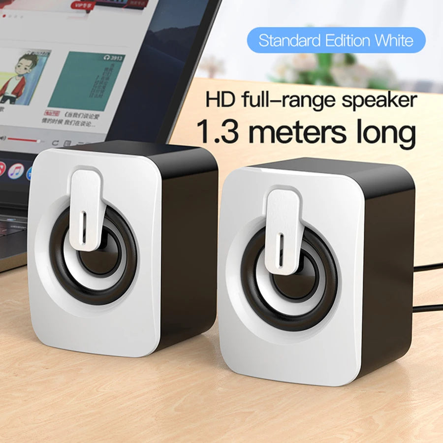 White mini desktop speaker pair with top USB ports and circular speaker drivers