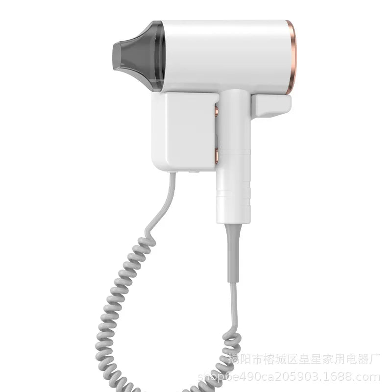 White 1600W wall-mounted hair dryer with nozzle attachment, rose gold accents, and coiled cord for hotels and homes.