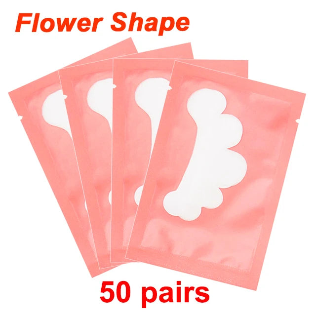 Flower shape lint-free under-eye gel patches in pink individual sachets for eyelash extension application.