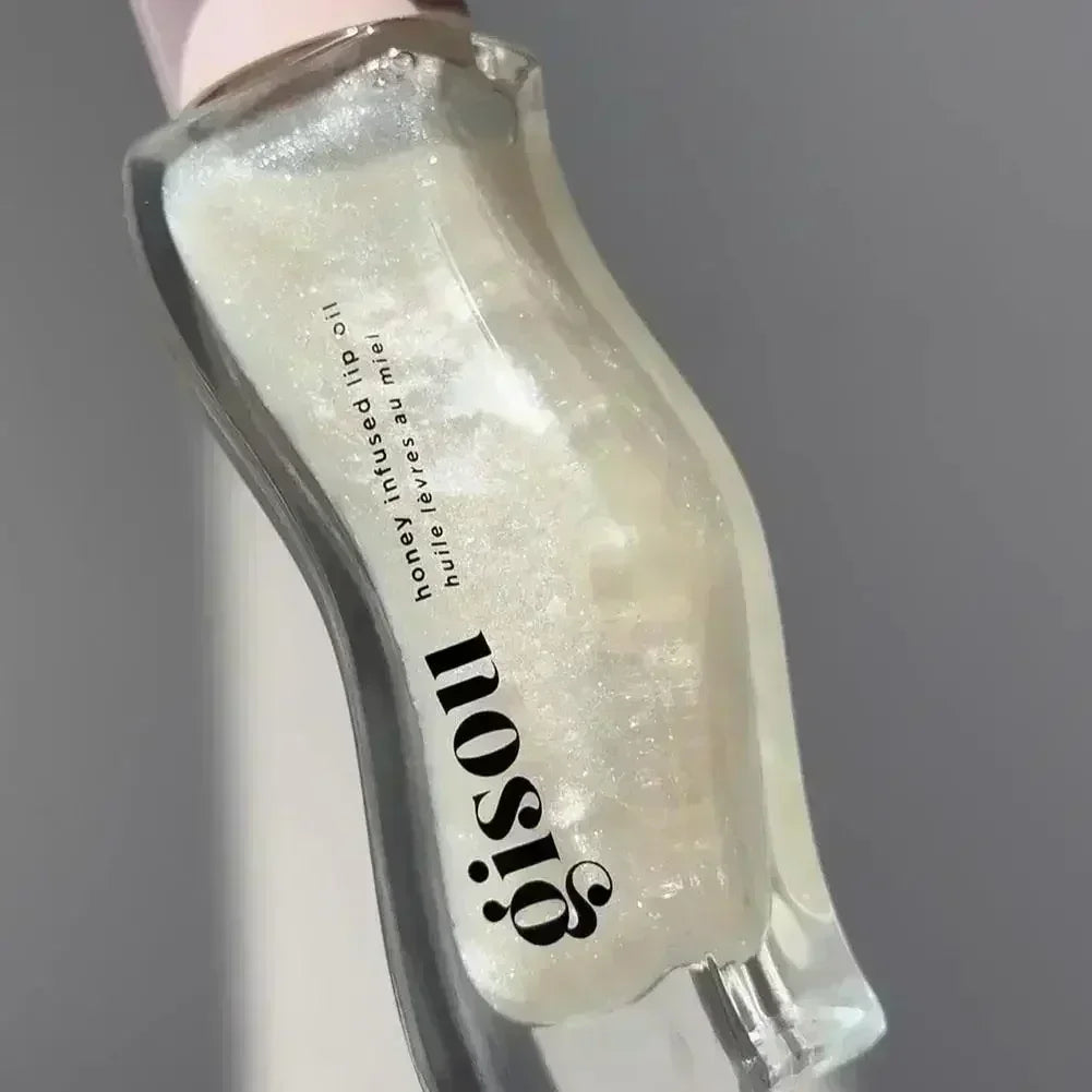 Gisou Honey Infused Lip Oil in shimmer finish, moisturizing liquid formula for glossy, hydrated lips.