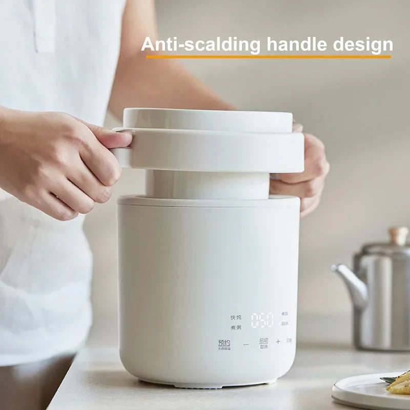 White mini cooker with anti-scalding handle, held up for pouring or carrying