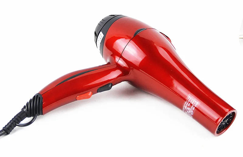 Shiny red 2300W professional salon hair dryer with long cord, ergonomic handle, and speed control settings.