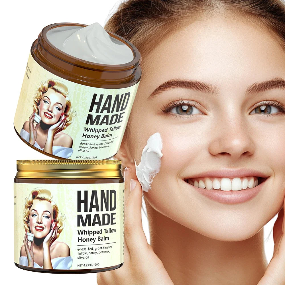 ENVISHA handmade whipped tallow honey face cream in gold jar applied to a smiling woman's cheek for skin firming.