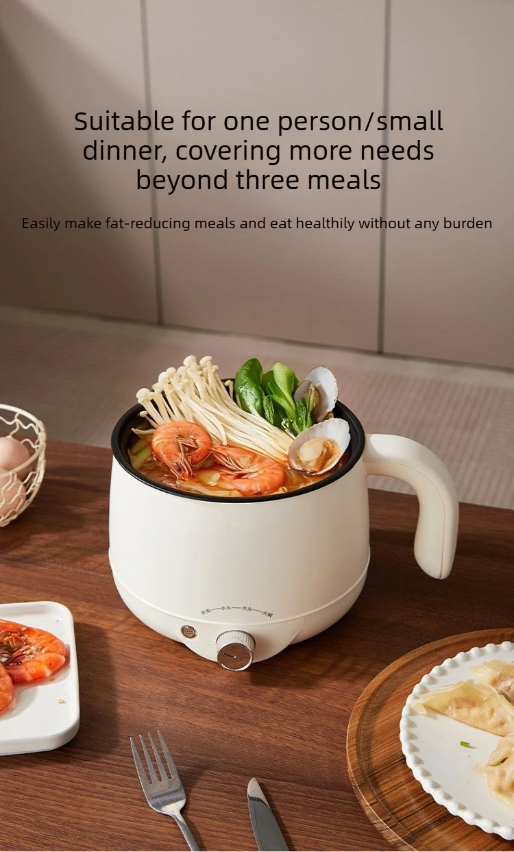White electric hot pot with seafood and vegetables inside, front knob on base
