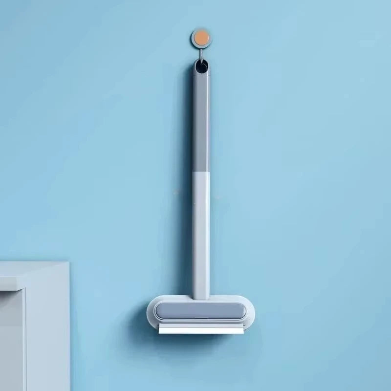 Gray manual pet hair remover tool for carpets and furniture, efficient lint cleaner for dog and cat fur.