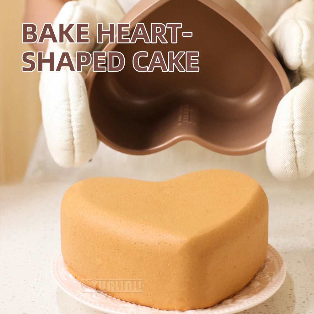Heart-shaped bake insert mold holding a finished cake, with hands above.