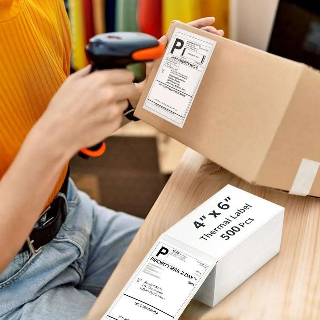 Hand placing a 4x6 thermal shipping label on a cardboard package