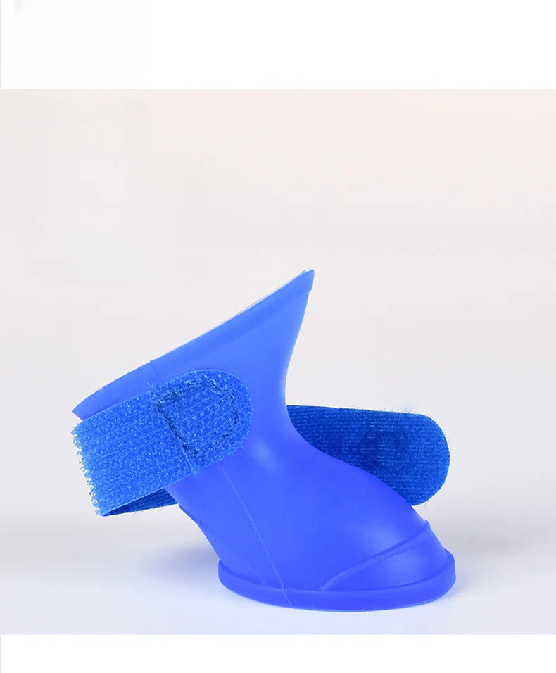 Blue waterproof, non-slip silicone dog rain boots with secure Velcro strap for dry, protected paws outdoors.