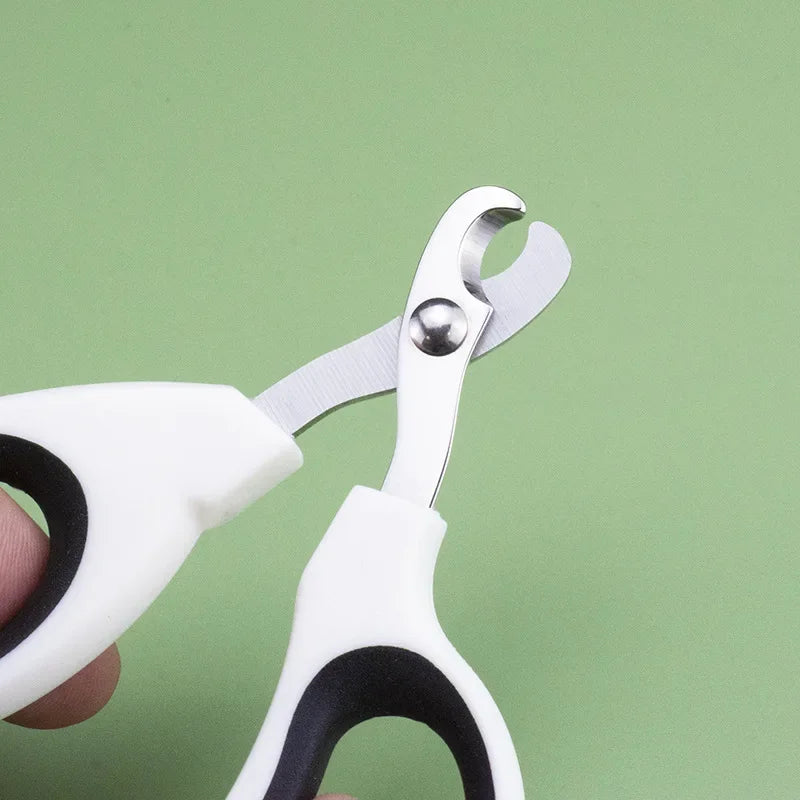 Professional stainless steel cat and dog nail clippers with white non-slip grips for safe, easy pet claw trimming.