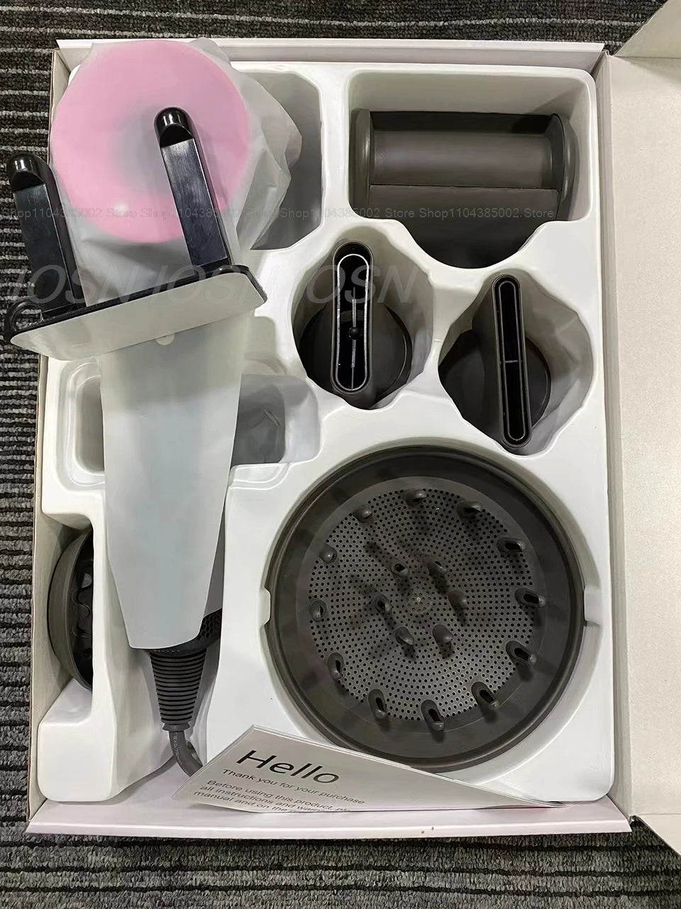 Professional leafless negative ion hair dryer set with pink head, magnetic styling attachments, and diffuser in box.