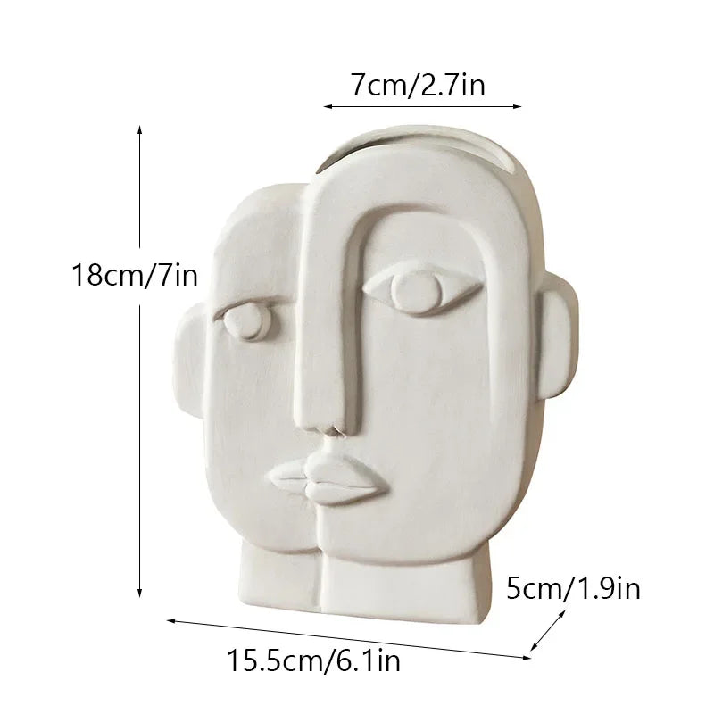 White ceramic face vase with curved top and side handle, front view, 18cm height