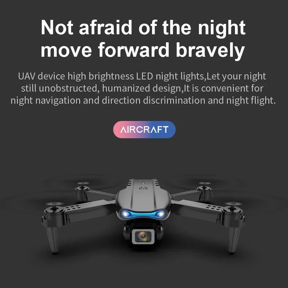Grey quadcopter drone with front-facing blue LED navigation lights for night flight.