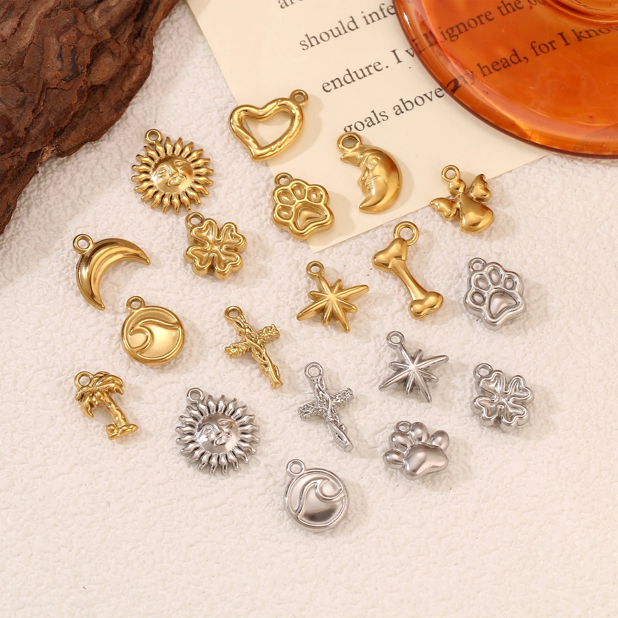 Gold and silver stainless steel pet paw and nature charms for DIY pet necklaces, bracelets, and jewelry making.