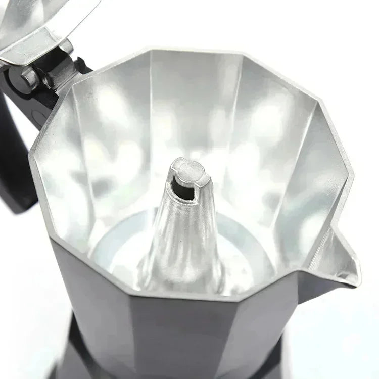 Interior view of a silver aluminum moka pot espresso maker with a black handle and classic octagonal design.