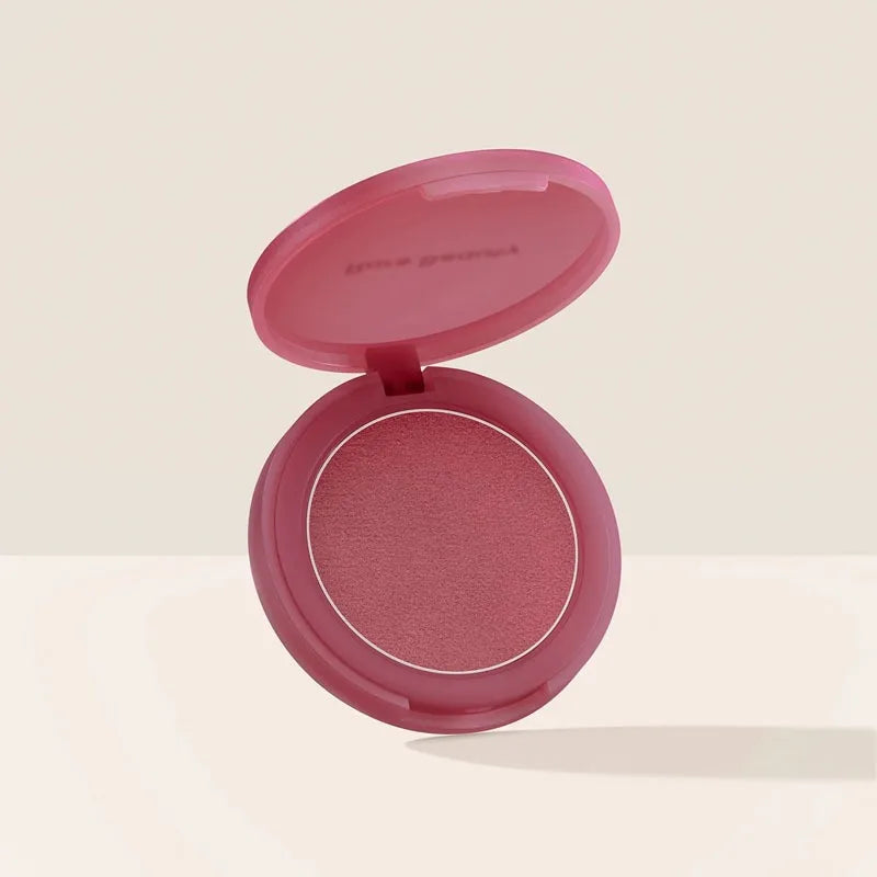 Rare Beauty powder blush in a soft pink compact, featuring a smooth, matte-finish berry shade for radiant color.