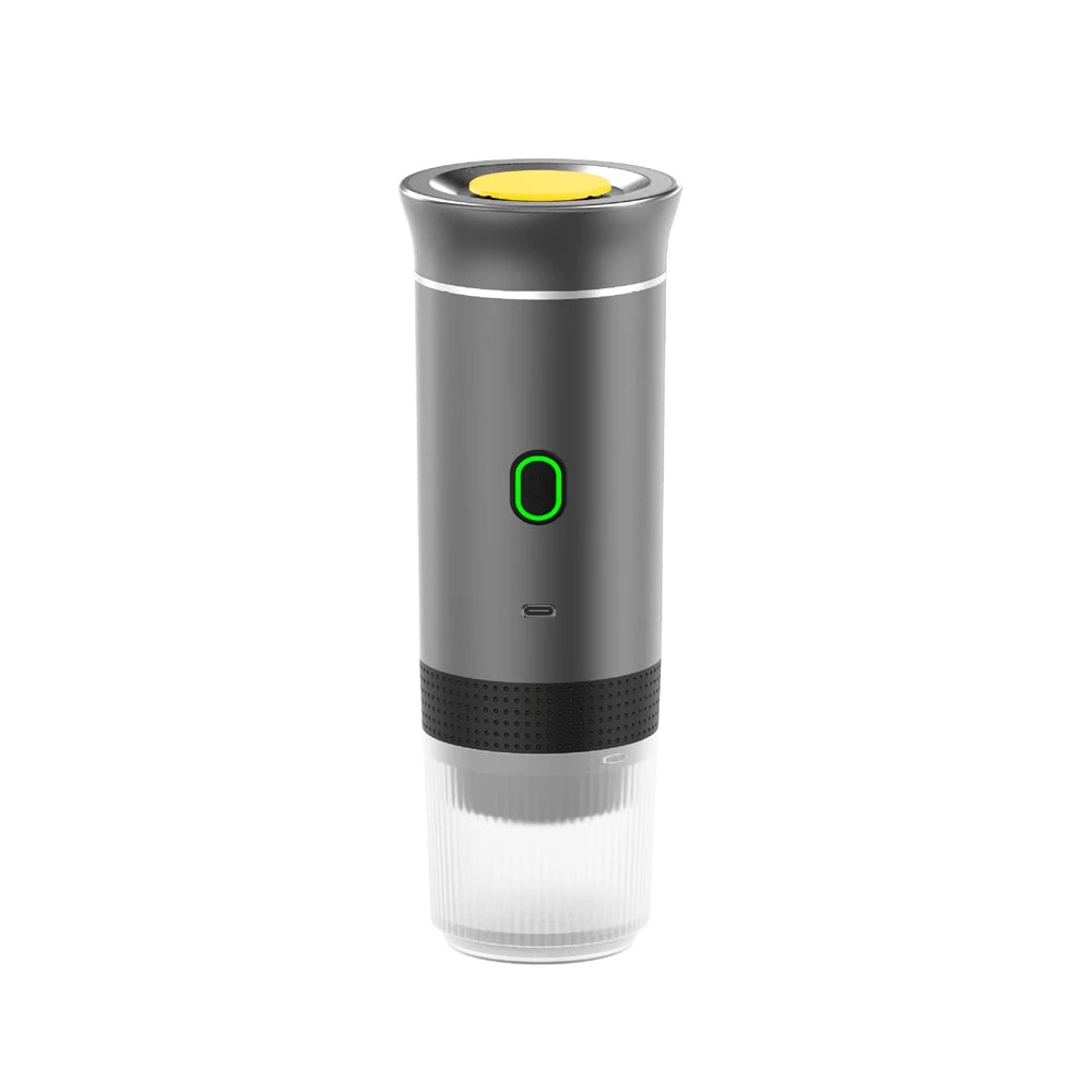 Portable electric espresso maker in matte grey with yellow button, clear base, and illuminated green power switch.
