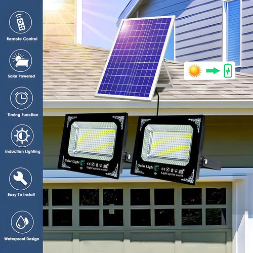 Black dual solar flood lights mounted below a solar panel on a house exterior.