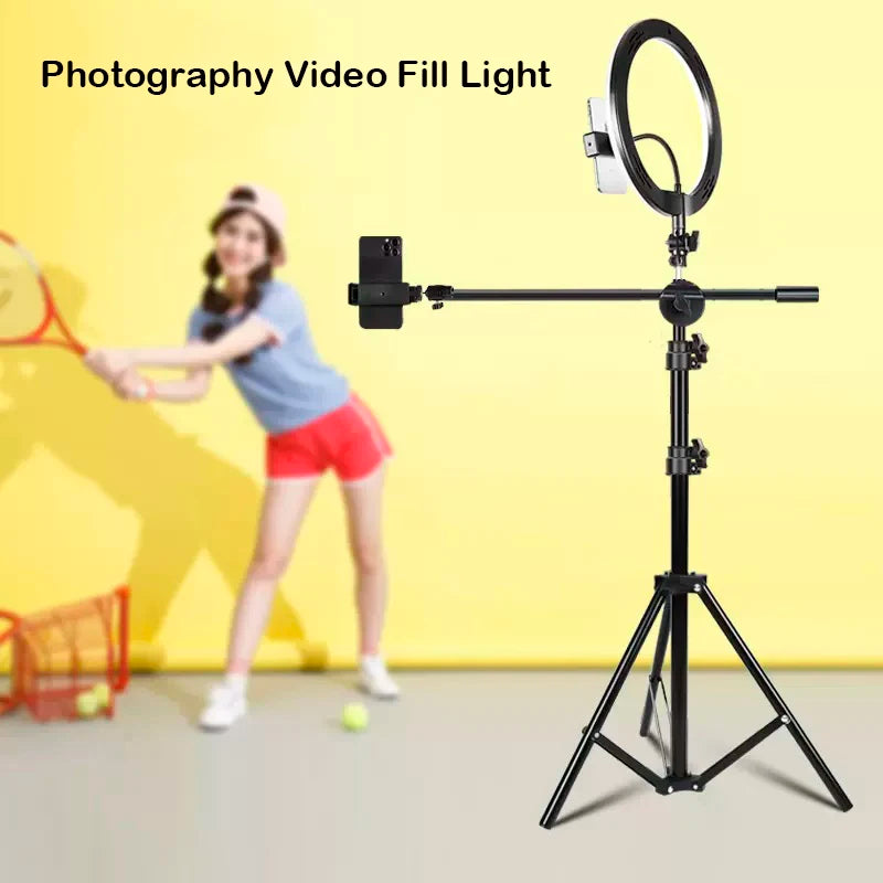 Black metal ring light stand with horizontal arm for phone mounting, used for photography and video recording.