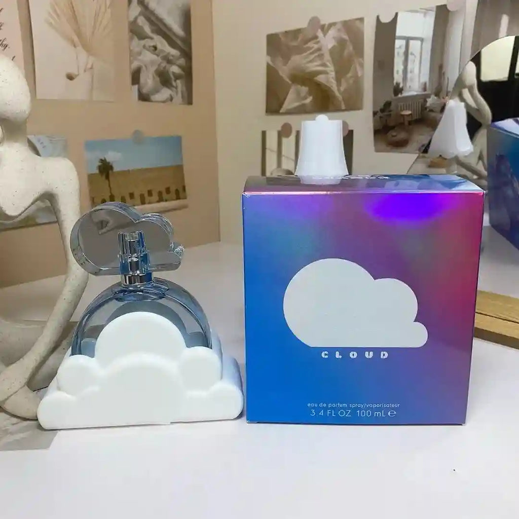 Cloud eau de parfum, 100ml. A round blue glass bottle in a white cloud base next to a metallic iridescent gift box.
